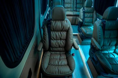 Comfortable interior of a passenger bus with soft seats Stock Photos