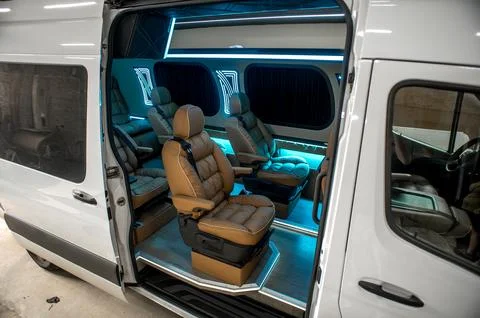 Comfortable interior of a passenger bus with soft seats Stock Photos