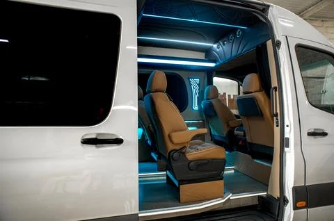 Comfortable interior of a passenger bus with soft seats Stock Photos