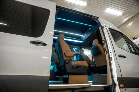 Comfortable interior of a passenger bus with soft seats Stock Photos