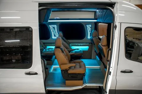 Comfortable interior of a passenger bus with soft seats Stock Photos