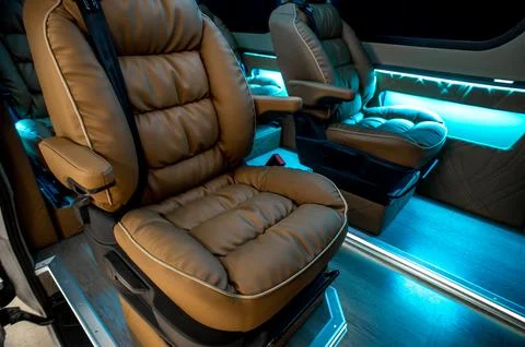 Comfortable interior of a passenger bus with soft seats Stock Photos
