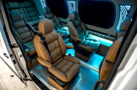 Comfortable interior of a passenger bus with soft seats Stock Photos