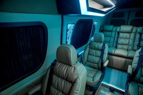 Comfortable interior of a passenger bus with soft seats Stock Photos