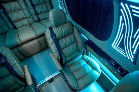 Comfortable interior of a passenger bus with soft seats Stock Photos