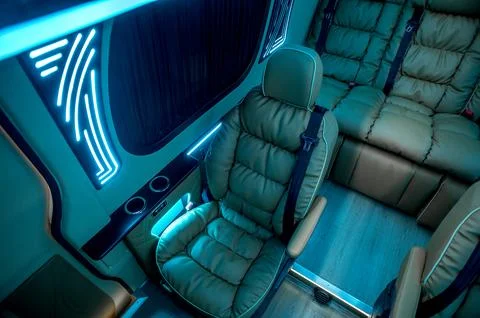 Comfortable interior of a passenger bus with soft seats Stock Photos