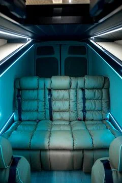 Comfortable interior of a passenger bus with soft seats Stock Photos