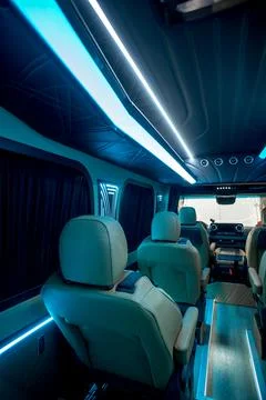 Comfortable interior of a passenger bus with soft seats Stock Photos