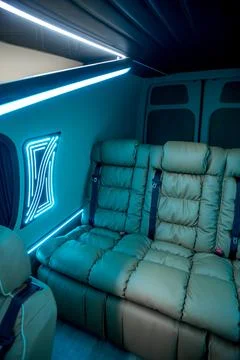 Comfortable interior of a passenger bus with soft seats Stock Photos