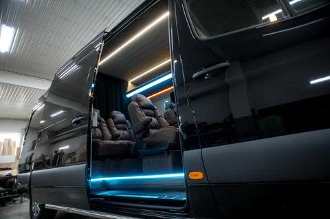 Comfortable interior of a passenger bus with soft seats Stock Photos