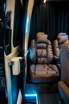 Comfortable interior of a passenger bus with soft seats Stock Photos