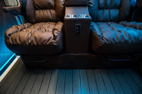 Comfortable interior of a passenger bus with soft seats Stock Photos