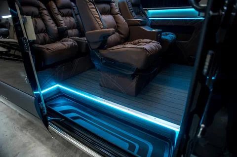 Comfortable interior of a passenger bus with soft seats Stock Photos