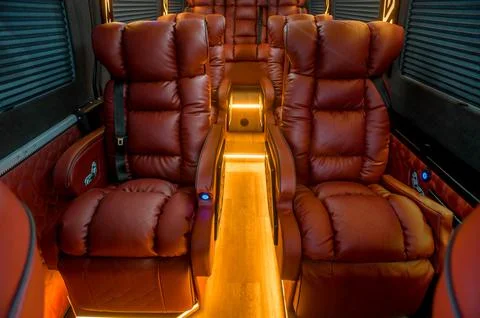 Comfortable interior of a passenger bus with soft seats Stock Photos