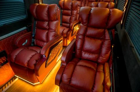 Comfortable interior of a passenger bus with soft seats Stock-Fotos