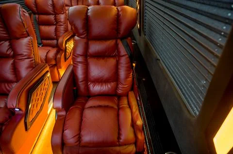 Comfortable interior of a passenger bus with soft seats Stock Photos