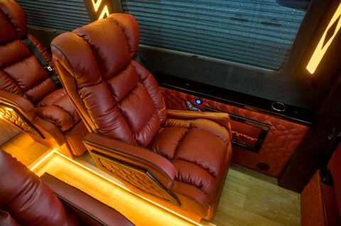 Comfortable interior of a passenger bus with soft seats Stock Photos