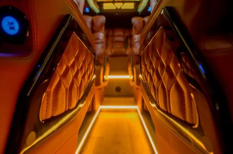 Comfortable interior of a passenger bus with soft seats Stock Photos