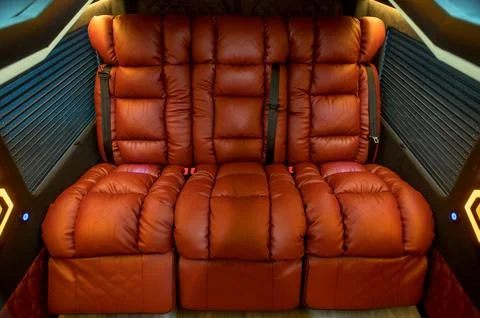 Comfortable interior of a passenger bus with soft seats Stock Photos