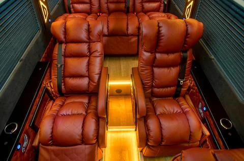 Comfortable interior of a passenger bus with soft seats Stock Photos