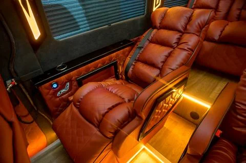 Comfortable interior of a passenger bus with soft seats Stock Photos