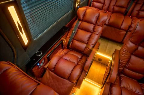 Comfortable interior of a passenger bus with soft seats Stock Photos