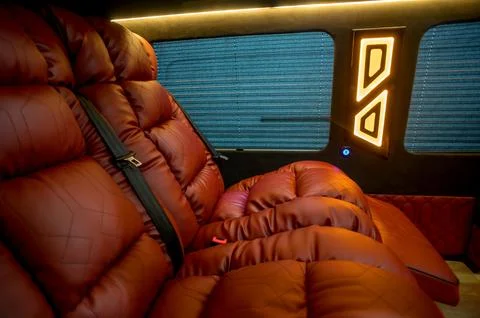 Comfortable interior of a passenger bus with soft seats Stock Photos