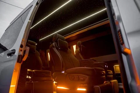 Comfortable interior of a passenger bus with soft seats Stock Photos