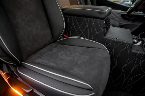 Comfortable interior of a passenger bus with soft seats Stock Photos