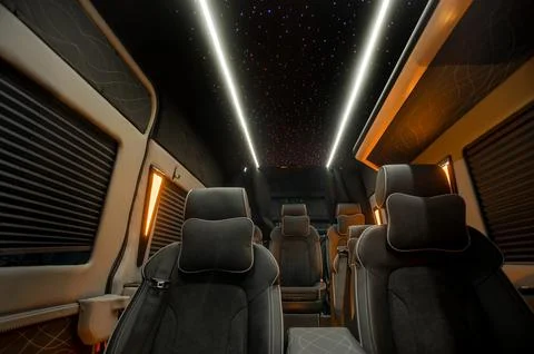 Comfortable interior of a passenger bus with soft seats Stock Photos