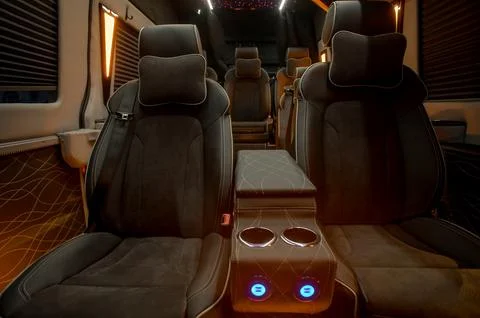 Comfortable interior of a passenger bus with soft seats Stock Photos