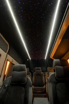 Comfortable interior of a passenger bus with soft seats Stock Photos