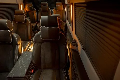 Comfortable interior of a passenger bus with soft seats Stock Photos