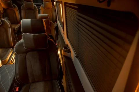 Comfortable interior of a passenger bus with soft seats Stock Photos