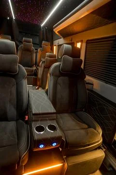 Comfortable interior of a passenger bus with soft seats Stock Photos