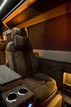 Comfortable interior of a passenger bus with soft seats Stock Photos