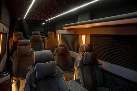 Comfortable interior of a passenger bus with soft seats Stock Photos