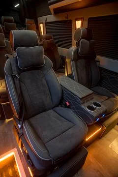 Comfortable interior of a passenger bus with soft seats Stock Photos