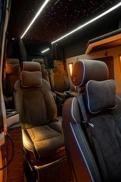 Comfortable interior of a passenger bus with soft seats Stock Photos