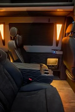 Comfortable interior of a passenger bus with soft seats Stock Photos