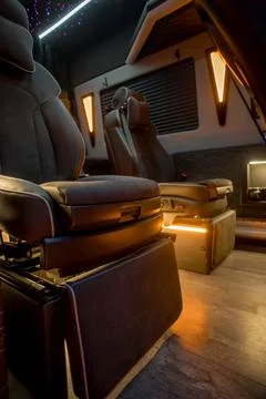 Comfortable interior of a passenger bus with soft seats Stock-Fotos