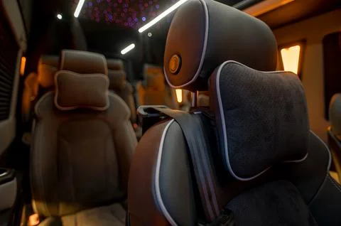 Comfortable interior of a passenger bus with soft seats Stock Photos