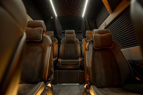 Comfortable interior of a passenger bus with soft seats Stock Photos