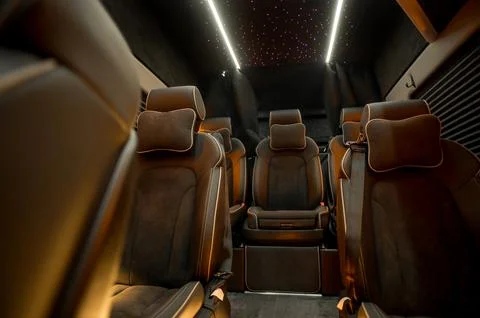 Comfortable interior of a passenger bus with soft seats Stock Photos