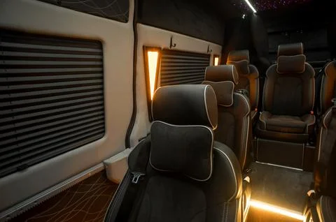 Comfortable interior of a passenger bus with soft seats Stock Photos