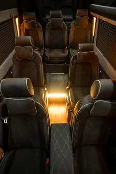 Comfortable interior of a passenger bus with soft seats Stock Photos