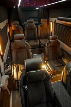 Comfortable interior of a passenger bus with soft seats Stock Photos