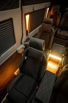 Comfortable interior of a passenger bus with soft seats Stock Photos