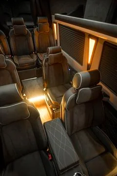 Comfortable interior of a passenger bus with soft seats Stock Photos