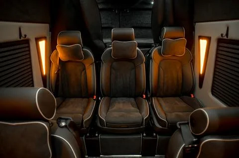 Comfortable interior of a passenger bus with soft seats Stock Photos